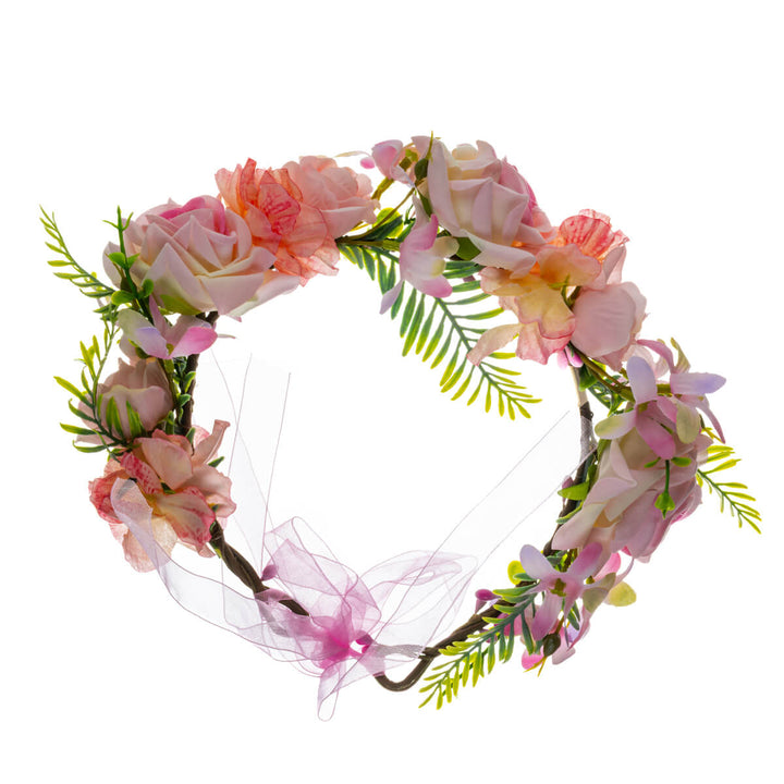 En ljusrosa blomsterkrans med rosor