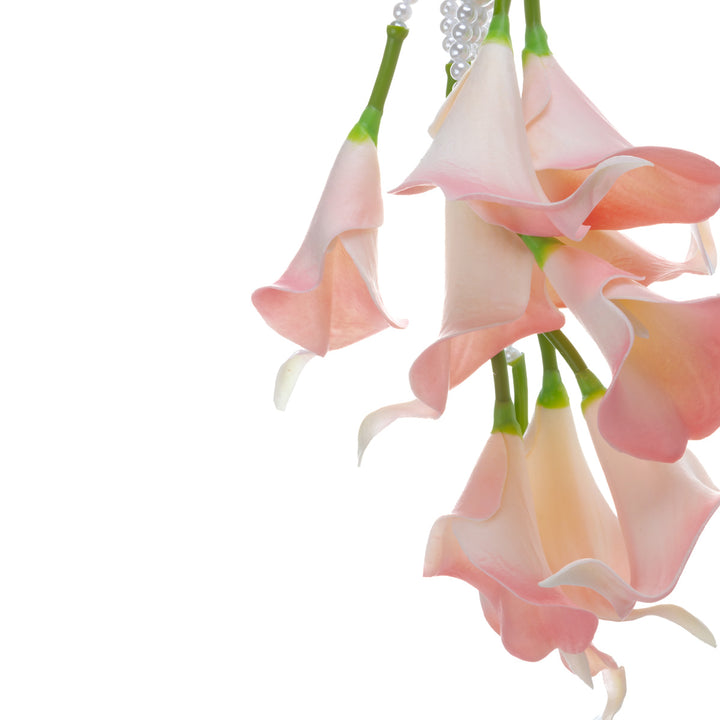 A calla lily bridal bouquet with a peach-colored artificial flower