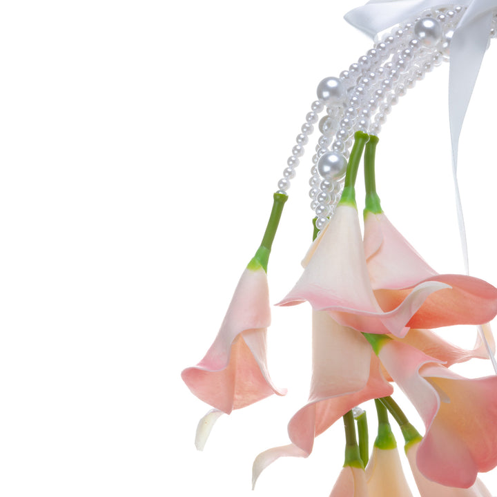 A calla lily bridal bouquet with a peach-colored artificial flower