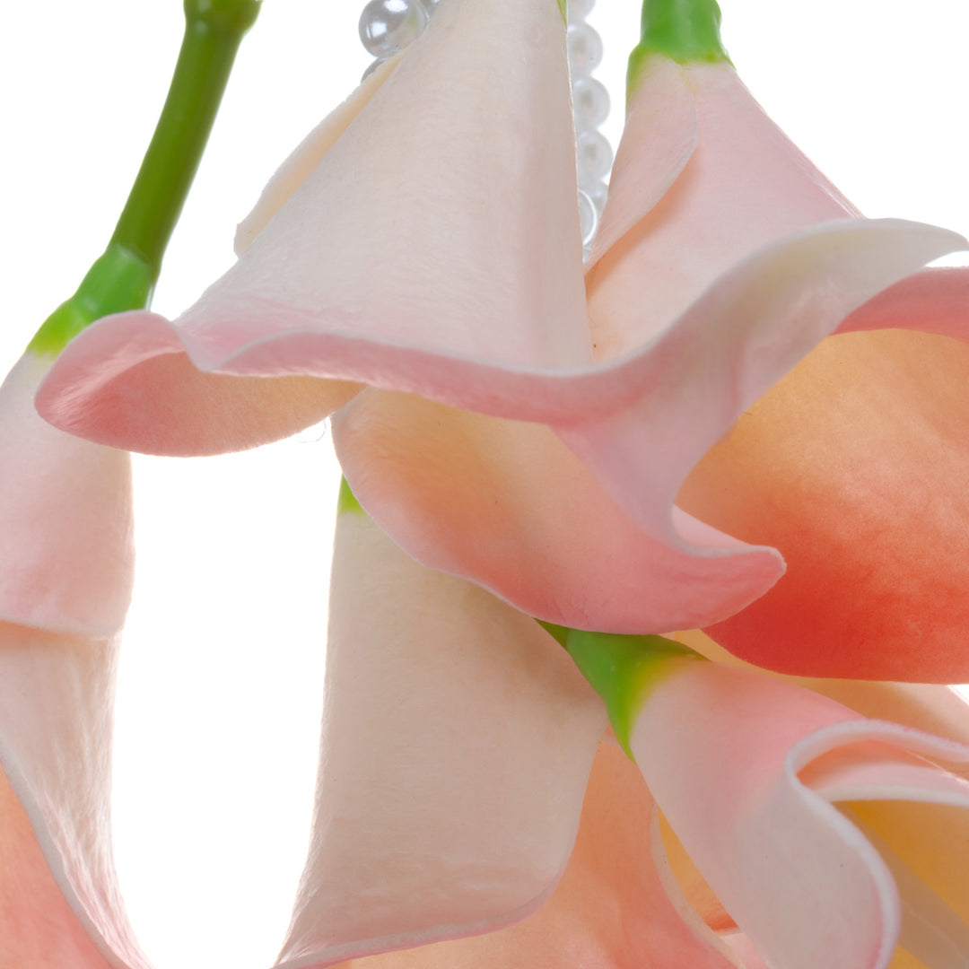 A calla lily bridal bouquet with a peach-colored artificial flower