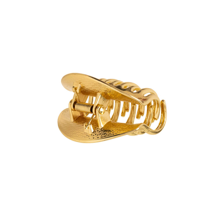 Ett litet krökt metalliskt hajtandklipp 4,5 cm